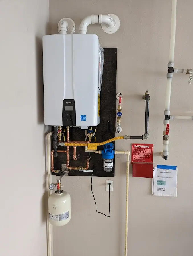 Professional plumber installing copper piping in a McKeesport home